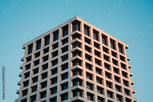 Modern office building exterior with geometric facade and windows