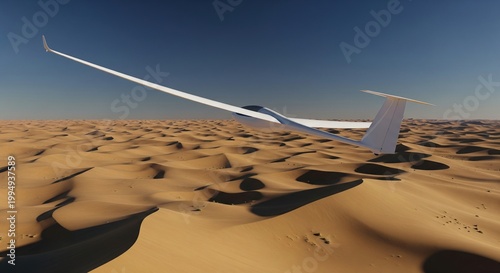 White modern glider flying low over vast sandy desert with endless dunes under clear blue sky