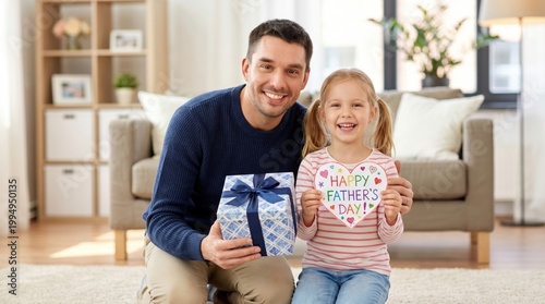 Happy father and little girl celebrating father's day with gifts indoors.