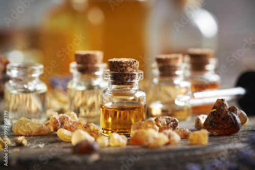 A bottle of frankincense essential oil with frankincense resin