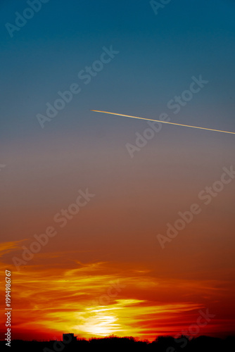 An airplane flying at sunset over the city of Minnesota, United States.