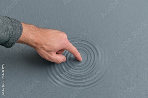 Finger touching glowing horizon above rippled surface, ideal for innovation, future interface, and conceptual technology content