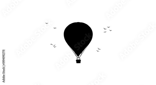 A silhouetted hot air balloon ascends with a flock of birds