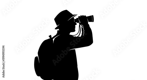 Silhouette of a man with binoculars and backpack observing the distance
