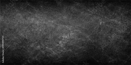 A dark and vintage black grunge background features an old textured stone wall pattern with a dirty grey concrete surface and a blank chalkboard frame for a moody design wallpaper