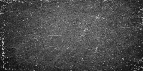 Dark rain drops on a textured black stone wall surface create a moody vintage grunge pattern