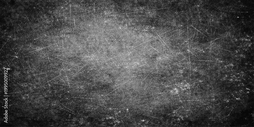 Aged dark grunge texture with a rough black and white abstract design featuring a dirty vintage concrete wall surface and grey stone pattern