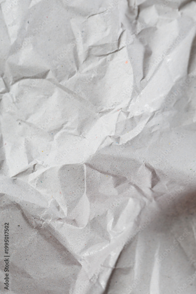 Obraz premium Close-up light kraft paper texture with visible wrinkles and recycled fibers, clean neutral background for mockups, branding, packaging and eco design concepts