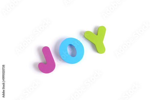 Colorful foam letters spelling JOY arranged at slight angle. Fun, educational, and vibrant concept.