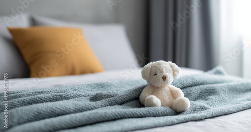 Soft teddy bear on cozy bed blanket