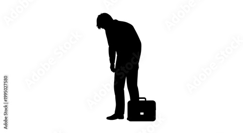 Silhouette of a man standing with a briefcase appearing dejected