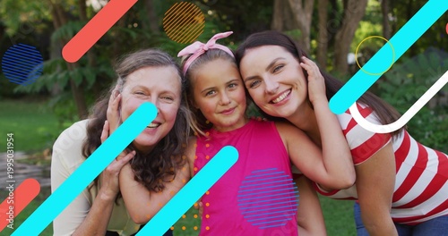 Smiling three generations standing on lawn, showing pink headband, striped shirt, graphic overlays