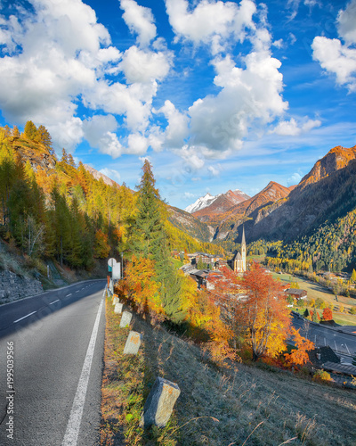 Bild auf Leinwand Picturesque autumn landscape  at Heiligenblut with St Vincent Church near Grossglockner mount