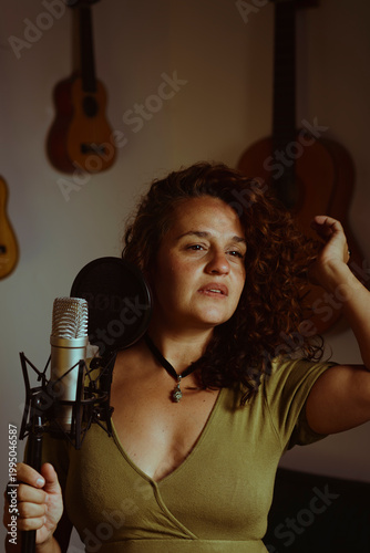 Woman singing and recording vocals in home studio