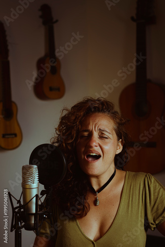 Woman singing and recording vocals in home studio