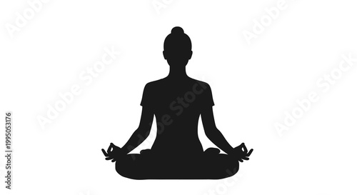 Silhouette of a woman practicing yoga in a meditative pose