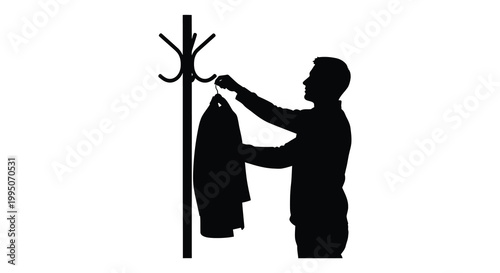 Silhouette of a man hanging a coat on a hallway coat rack