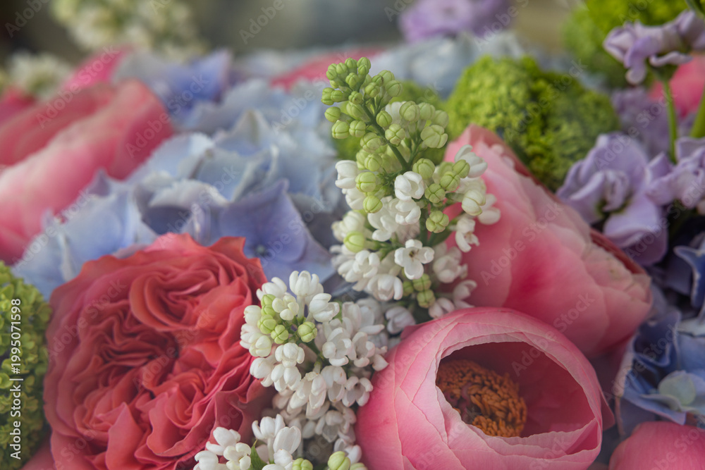 Fototapeta premium Macro shot of colorful bouquet with lilac roses and hydrangea