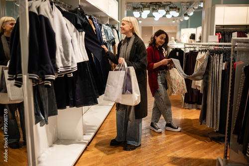 Картината върху платно Young women shopping for clothes in retail store
