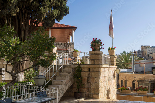 Jerusalem, Israel, April 17, 2026, Stone terrace with a staircase and a view of the Old City rooftops from the Austrian Hospice.