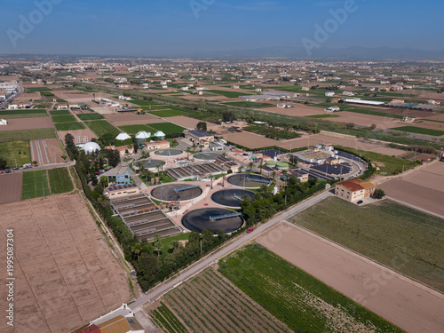 фотографія Aerial view of wastewater treatment plant showing circular sedimentation tanks,