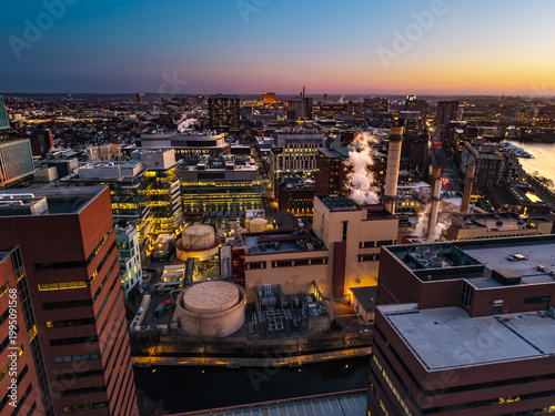 Boston industrial cityscape at sunset with steam and skyline