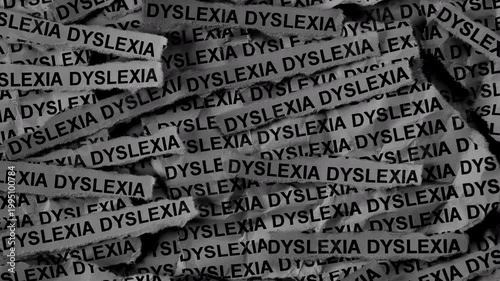 Strips of newspaper with the words Dyslexia typed on them. Black and white. Close up.