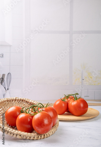 Tomatoes, beautiful red tomatoes in rustic bowls on a very bright kitchen counter, selective focus.