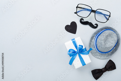 Happy Father's Day accessories on color background, top view
