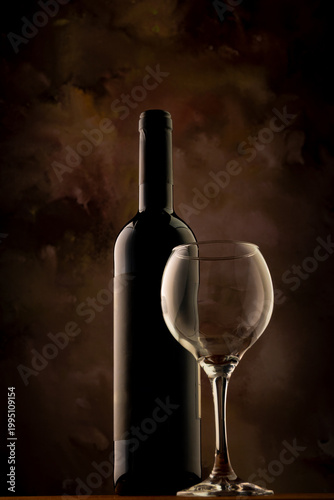 Bottle and wine glass, bottle and wine glass on a rustic wooden surface and abstract background, low key photo, selective focus.