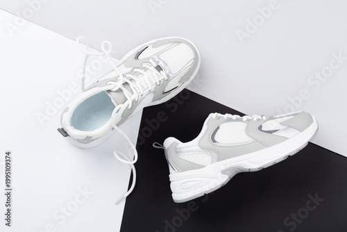 Fotografie Pair of sneakers on color background, top view