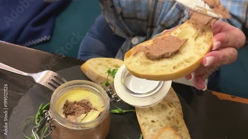 Gourmet Spreading Pate spread on bread with microgreens and baguette closeup appetizer serving Spreading Pate On a piece of Bread. High quality 4k footage
