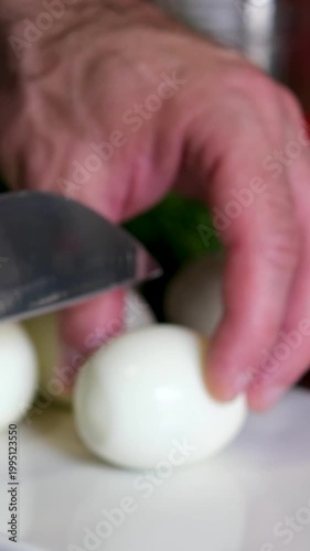 A male hand picks up boiled chicken eggs from the table as the camera glides through them. Dolly slider, close-up.