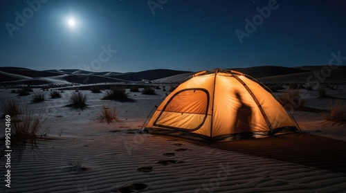 Glowing tent in desert at night under moonlight