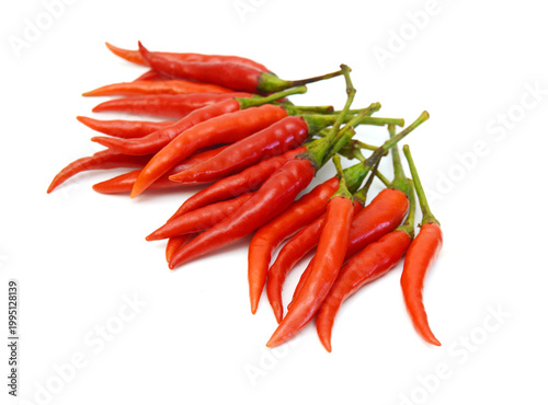 Stack red chili peppers and basil herb leaves  on the white