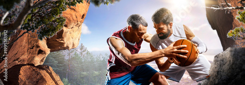 Basketball. Two basketball players practice on a basketball court in the wilderness. A beautiful landscape is in the background.