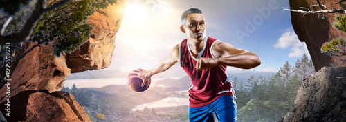 Basketball. A basketball player practices on a basketball court in the wilderness. A beautiful landscape is in the background.