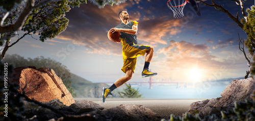 Basketball. A basketball player practices on a basketball court in the wilderness. A beautiful landscape is in the background.