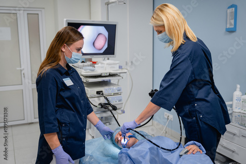 Schilderij op canvas Endoscopic examination with doctors and female patient in hospital, gastroscopy