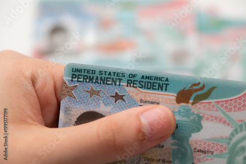 Close-up view of United States Permanent Resident cards stacked together. Concept of immigration, residency status, identity documentation, and legal authorization to live and work in the USA.