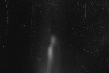 Black and white vintage film texture with heavy scratches and subtle light leak