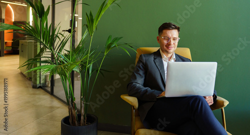 Bild auf Leinwand Business professional enjoys productive work session in modern office with green