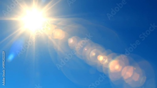 Bright sun with lens flare in a vibrant blue sky, creating a visually stunning and dynamic image