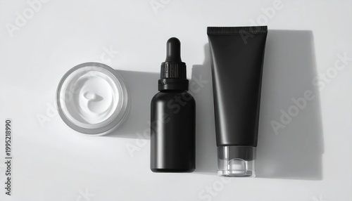 Minimalist Black Skincare Products Arranged on White Background.