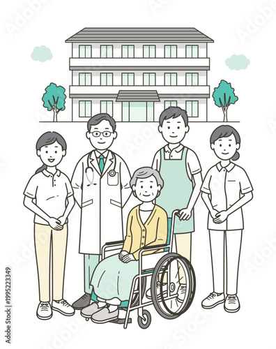 介護施設の前にいる車椅子に座る高齢女性と介護士と医師と看護師の集合写真
