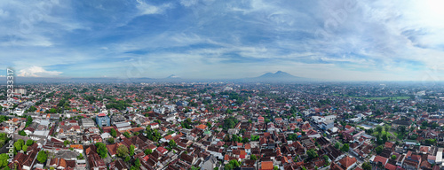 Quadro su tela Aerial landscape panorama of Yogyakarta city at morning with Mount Merapi, Merbabu, and Sumbing volcanoes