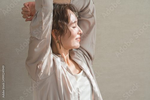 Canvas-taulu A relaxed woman basking in the sunlight in the living room.