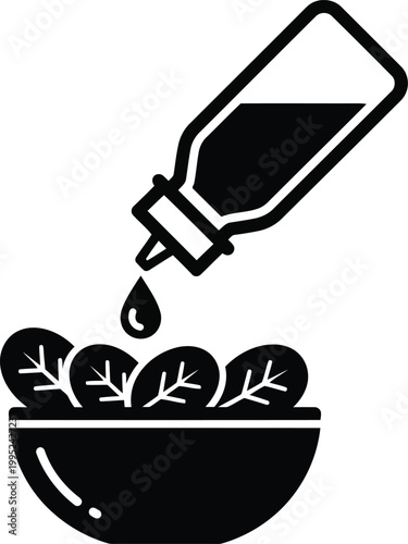 Black silhouette icon of a bottle pouring liquid dressing over a fresh green salad in a bowl