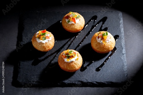 Gourmet Dahi Puri Appetizers with Garnishes on Dark Slate