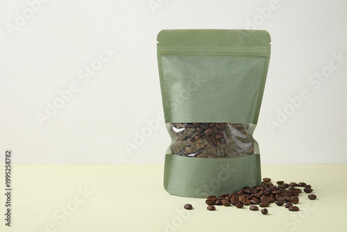 Bag of coffee beans on gree...